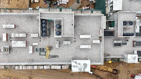 Construction site with a crane and a large building in the background Stock Photos