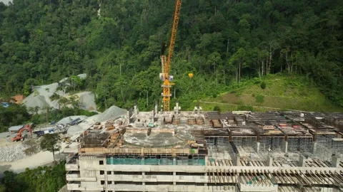 Construction Site with Crane and Workers Overlooking Green Forest Landscape Stock Footage 316450390