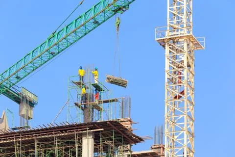 Construction site with crane and workers Stock Photos