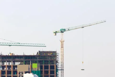 Construction site with crane and workers on blue sky Stock Photos