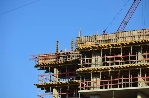 A construction site with a crane in the background.  Stock Photos