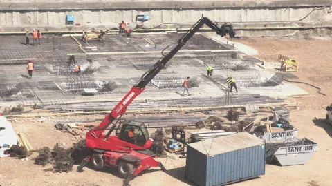 Construction Site - Crane lifting Container - Workers pouring Foundations Video stock 151157931