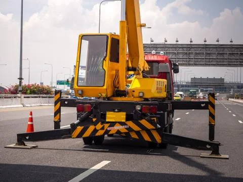 Construction site crane is lifting a led signboard for advertisement Foto stock
