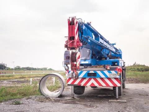 Construction site crane is lifting a led signboard for advertisement Foto stock