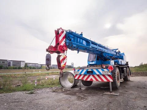 Construction site crane is lifting a led signboard for advertisement Foto stock