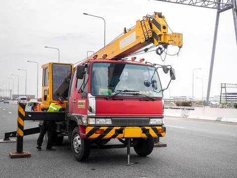 Construction site crane is lifting a led signboard for advertisement Foto stock