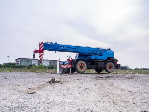 Construction site crane is lifting a led signboard for advertisement Stock Photos