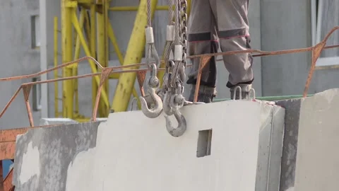 Construction site, crane lifting wall panel Stock Footage 98513350