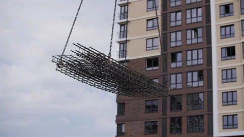 At the construction site, a crane moves the load Stock Footage 247546689