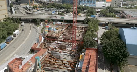 Construction site with crane moving and traffic road in Hong kong city Stock Footage 100008443