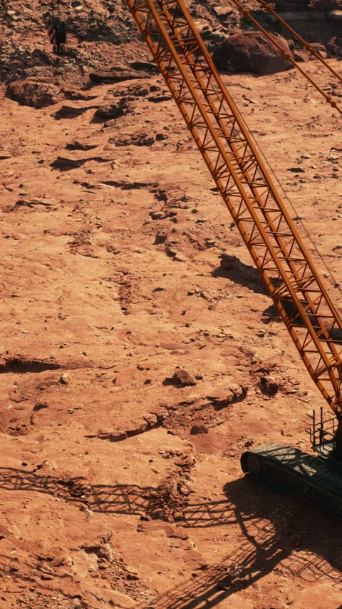 Construction site with crane on red earth during daytime work hours Stock Footage 339510526