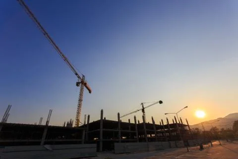Construction site with crane on sunset Stock Photos