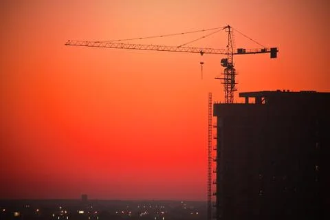 Construction site with a crane at sunset Stock Photos