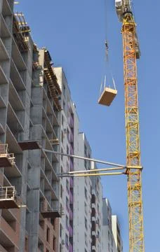 Construction site. A crane is working on the construction of a modern  building Stock Photos