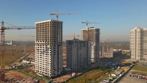 Construction site with cranes. Aerial camera approaching concrete frames of  Stock Footage 162887821