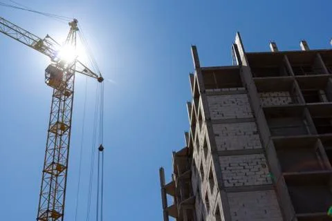 Construction site with cranes on a background of blue sky. The concept of the Stock Photos