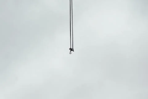 Construction site cranes chains with hooks in the air Foto stock