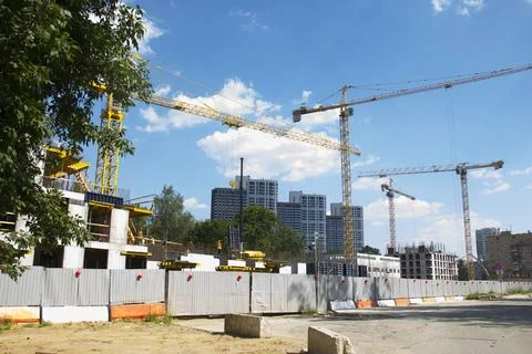Construction site with cranes. Construction site with a blue sky Stock Photos