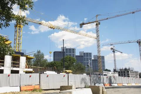 Construction site with cranes. Construction site with a blue sky Stock Photos