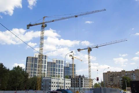 Construction site with cranes. Construction site with a blue sky Stock Photos