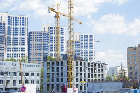Construction site with cranes. Construction site with a blue sky Stock Photos
