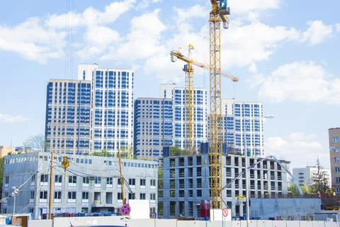 Construction site with cranes. Construction site with a blue sky Stock Photos