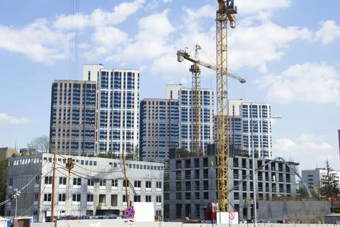 Construction site with cranes. Construction site with a blue sky Stock Photos
