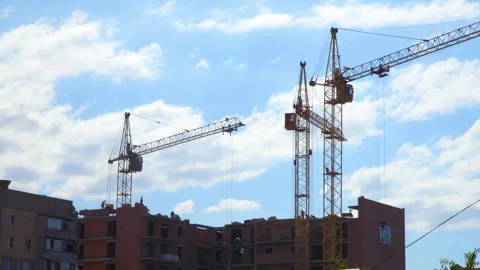 Construction site with cranes on sky background. Video stock 259390184