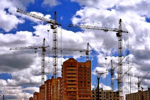 Construction site with cranes on sky background Stock Photos