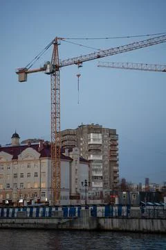 Construction site with cranes under construction in an urban environment Stock Photos