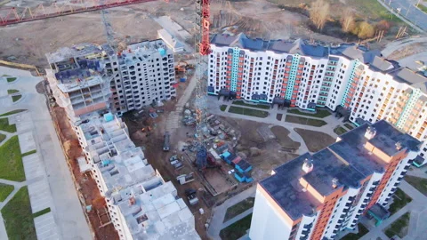 Construction site at dawn. Claimed multi-storey houses are visible. Construction Stock Footage 152978693