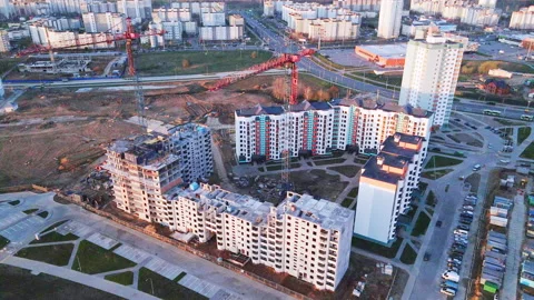 Construction site at dawn. Claimed multi-storey houses are visible. Construction Stock Footage 152980290