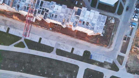 Construction site at dawn. Claimed multi-storey houses are visible. Construction Stock Footage 152980609