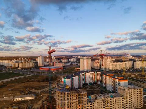 Construction site at dawn. Claimed multi-storey houses are visible. Construct Stock Photos