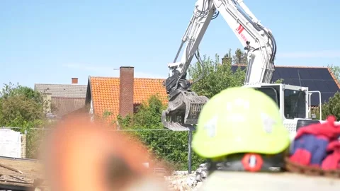 Construction site, demolition - Close up Helmet with excavator in the background Video stock 130994352