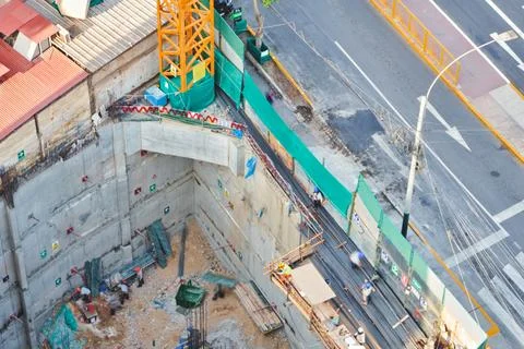 Construction site developing urban infrastructure with crane and workers Stock Photos