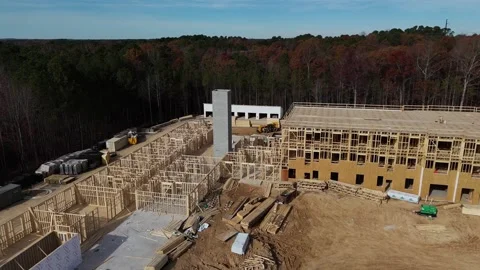 Construction site development requires complex framing, heavy machinery Stock Footage 306020247