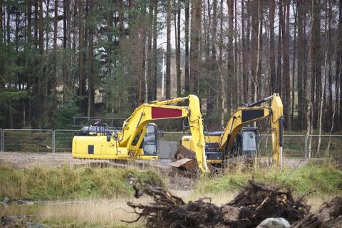 Construction site digger yellow during excavation on building site Stock Photos