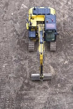 Construction site digger yellow during excavation on building site Stock Photos