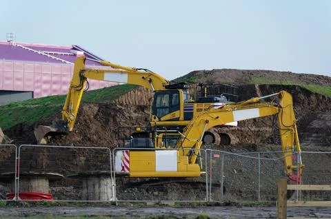Construction site digger yellow during excavation on building site Stock Photos