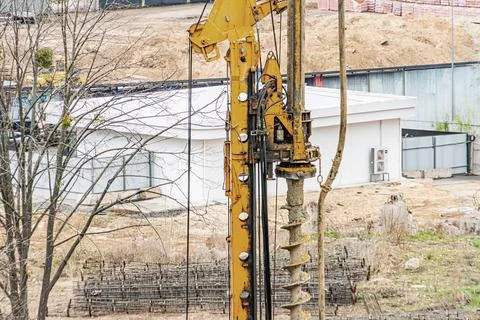 Construction Site with Drilling Rig and Partially Built Structure Stock Photos