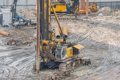 Construction Site with Drilling Rig and Excavator Machinery Stock Photos