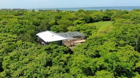 Construction site drone, metallic roof structure in rural land, ocean view Stock Footage 154838136