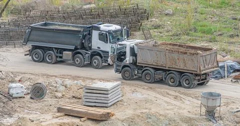 Construction Site with Dump Trucks and Materials Stock Photos