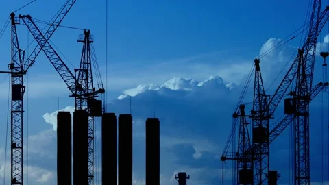 Construction site at dusk with purple sky. Silhouette of high tower cranes works Stock Footage 160389966