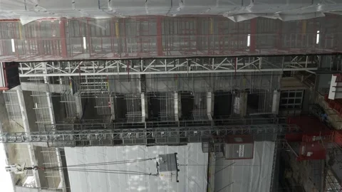 Construction Site Elevator Going Up With Crane Lifting Materials. Vertical Video stock 143150053