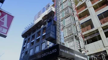 Construction Site Elevator Moves Up Side of Building Under Construction Stock Footage 85673114