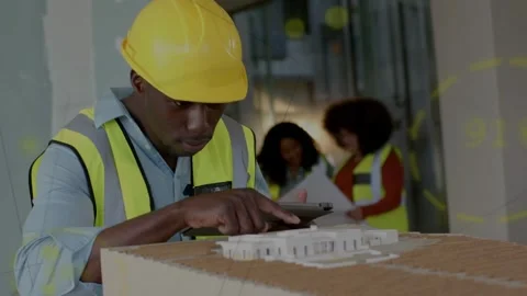 Construction site engineer tapping tablet and pointing at scale model, Stock Footage 332841433