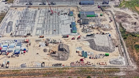Construction site with equipment and materials near a power station Stock Footage 341331772