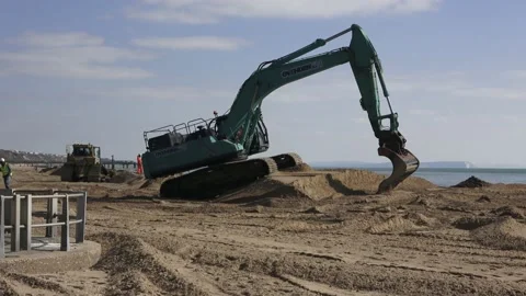 Construction Site Excavator Moving Along The Beach Stock Footage 149933754
